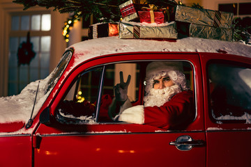 Portrait of Santa Claus. Santa Claus is driving a car