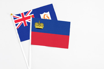 Liechtenstein and Anguilla stick flags on white background. High quality fabric, miniature national flag. Peaceful global concept.White floor for copy space.