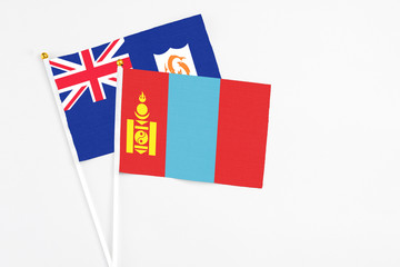 Mongolia and Anguilla stick flags on white background. High quality fabric, miniature national flag. Peaceful global concept.White floor for copy space.