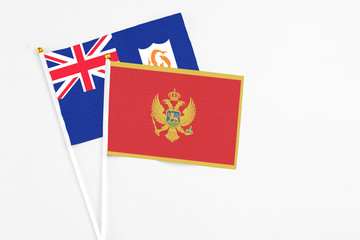 Montenegro and Anguilla stick flags on white background. High quality fabric, miniature national flag. Peaceful global concept.White floor for copy space.