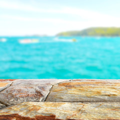 Brown stone table top with blurred nature scene tropical beach