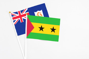Sao Tome And Principe and Anguilla stick flags on white background. High quality fabric, miniature national flag. Peaceful global concept.White floor for copy space.