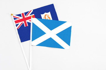 Scotland and Anguilla stick flags on white background. High quality fabric, miniature national flag. Peaceful global concept.White floor for copy space.