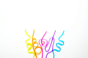 Tubules for cocktails of different shapes and colors on a white background. The concept of a holiday, fun, party. Place for text