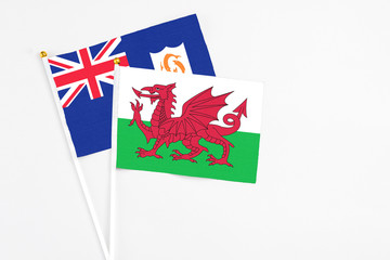 Wales and Anguilla stick flags on white background. High quality fabric, miniature national flag. Peaceful global concept.White floor for copy space.