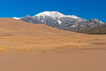Fototapeta na wymiar Sand Dunes and Snowy Mountains