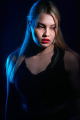 Fototapeta na wymiar portrait of a beautiful girl with red lips on a blue background