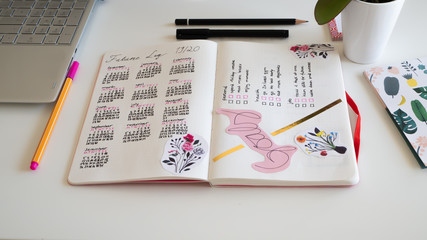 Journal life style, Bullet Journal - Planer - Notebook - top view with utensils arranged on white background, orchid, pencils, sticky notes