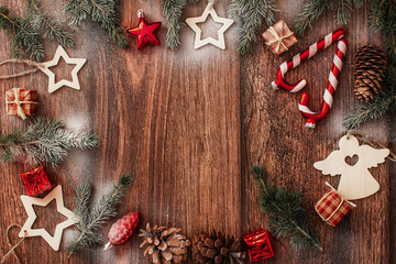 Fototapeta premium Christmas decorations and fir branches on brown wooden background