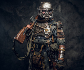 Portrait of a man in interesting costume of dark apocalypse warrior at photo studio.