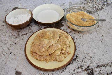 Fried chicken ingredients with chicken breasts ready to be cooked