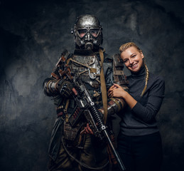 Happy smiling woman is posing for photographer with dark apocalypse warrior.