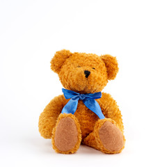 cute brown teddy bear with a blue bow on his neck