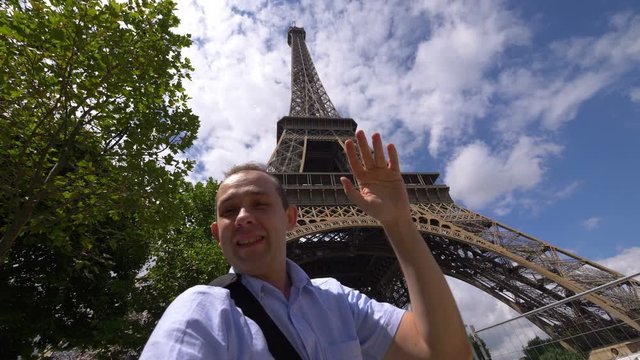 Man taking selfie with a view on Eiffel Tower in Paris in 4k slow motion 120fps