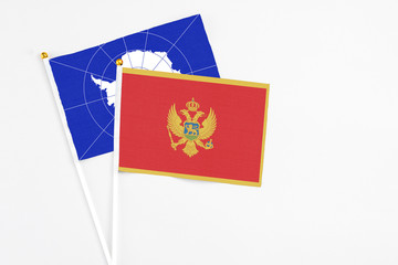 Montenegro and Antarctica stick flags on white background. High quality fabric, miniature national flag. Peaceful global concept.White floor for copy space.