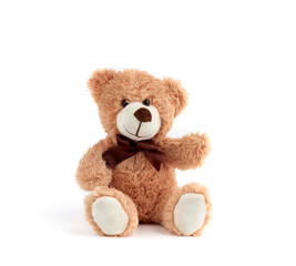 cute brown teddy bear with a bow around the neck sit on a white background