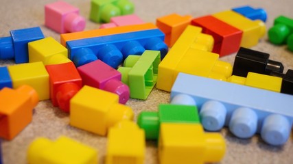 Colourful building block toy pieces scattered randomly