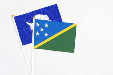 Solomon Islands and Antarctica stick flags on white background. High quality fabric, miniature...