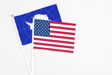 United States and Antarctica stick flags on white background. High quality fabric, miniature national flag. Peaceful global concept.White floor for copy space.