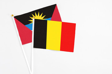 Belgium and Antigua and Barbuda stick flags on white background. High quality fabric, miniature national flag. Peaceful global concept.White floor for copy space.