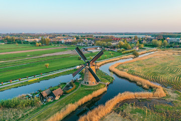 Fototapeta na wymiar Aerial drone shot view of Kinderdijk Wind Mills in the filed near Rotterdam in Netherlands