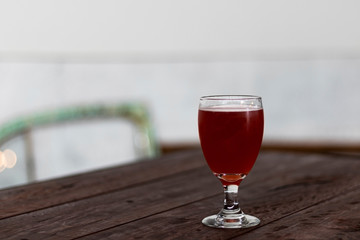 pink rose beer savor in fancy glass on wooden vintage style table plank have copy space interior bar 