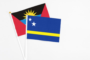Curacao and Antigua and Barbuda stick flags on white background. High quality fabric, miniature national flag. Peaceful global concept.White floor for copy space.