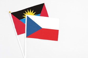 Czech Republic and Antigua and Barbuda stick flags on white background. High quality fabric, miniature national flag. Peaceful global concept.White floor for copy space.