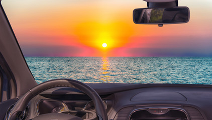 Car windshield view of scenic sunset on the mediterranean sea