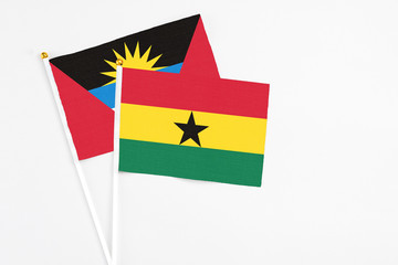 Ghana and Antigua and Barbuda stick flags on white background. High quality fabric, miniature national flag. Peaceful global concept.White floor for copy space.