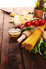 Pasta, vegetables, herbs and spices for Italian food on rustic table