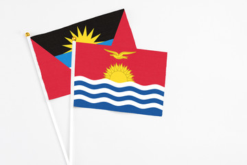 Kiribati and Antigua and Barbuda stick flags on white background. High quality fabric, miniature national flag. Peaceful global concept.White floor for copy space.