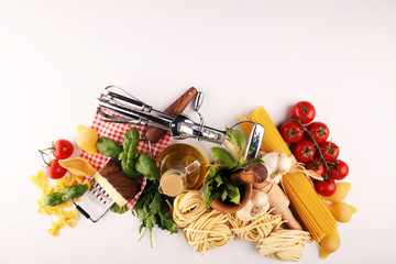 Pasta, vegetables, herbs and spices for Italian food on rustic table