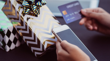 Ordering gifts By smartphone and iPad devices Online Pay via credit card. Concept of gift giving on special occasions and festivals.