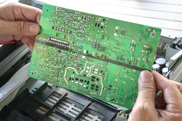 Hands holding PCB board