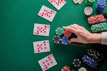 A straight flush, laid out on the table and a lot of chips. Poker, Casino, Winning combination. Player raises bets and wins