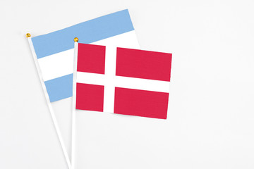 Denmark and Argentina stick flags on white background. High quality fabric, miniature national flag. Peaceful global concept.White floor for copy space.