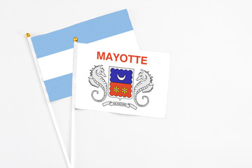 Mayotte and Argentina stick flags on white background. High quality fabric, miniature national flag. Peaceful global concept.White floor for copy space.
