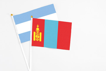 Mongolia and Argentina stick flags on white background. High quality fabric, miniature national flag. Peaceful global concept.White floor for copy space.
