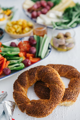 Turkish Breakfast, egg, tomatoes, Cucumber, olive, bread. Turkish fast food bagel called Simit.