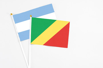 Republic Of The Congo and Argentina stick flags on white background. High quality fabric, miniature national flag. Peaceful global concept.White floor for copy space.
