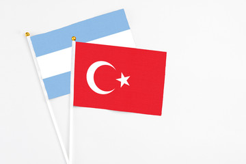 Turkey and Argentina stick flags on white background. High quality fabric, miniature national flag. Peaceful global concept.White floor for copy space.