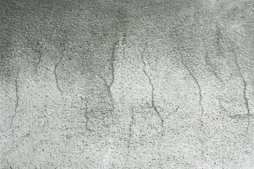 Cement wall texture with cracked and rough surfaces.