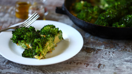 Slice of broccoli frittata on a white plate. Vegetarian diet. Keto diet. Keto omelet with broccoli.