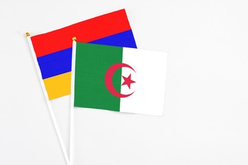 Algeria and Armenia stick flags on white background. High quality fabric, miniature national flag....