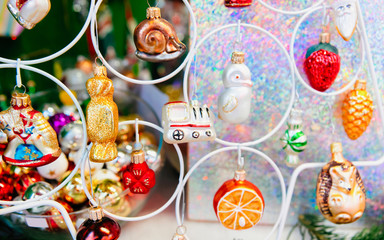 Fototapeta na wymiar Christmas Tree Decorations on Christmas Market at Gendarmenmarkt in Winter Berlin, Germany. Advent Fair and Stalls with Crafts Items on the Bazaar. Glass