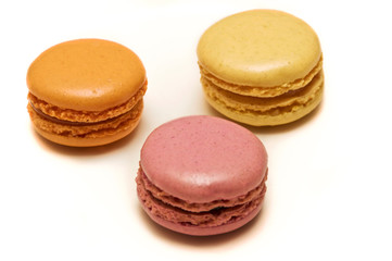 An assortment of three french macaron almond cookies of different flavors and colors.