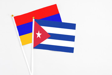 Cuba and Armenia stick flags on white background. High quality fabric, miniature national flag. Peaceful global concept.White floor for copy space.