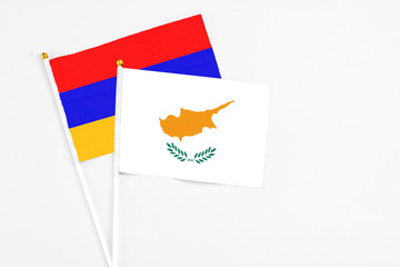 Cyprus and Armenia stick flags on white background. High quality fabric, miniature national flag. Peaceful global concept.White floor for copy space.