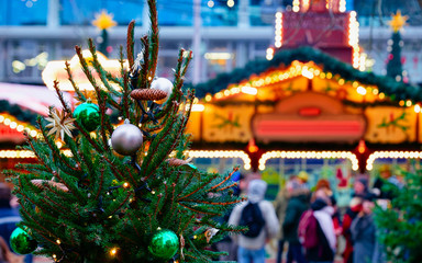 Christmas tree decorations in Christmas market in Germany in Europe winter. German Night street Xmas and holiday fair in European city or town. Kaiser Wilhelm Memorial Church, Berlin. Glass